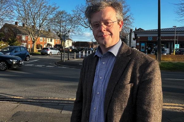 Andrew Makinson inspecting the proposed crossing site on Booker Avenue