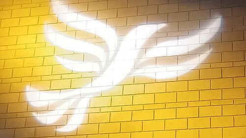 Lib Dem logo bird projected on blockwork