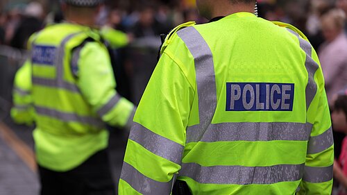 Two Police Office facing away from the camera