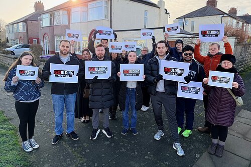 Group of people holding signs saying "Goulding must go"